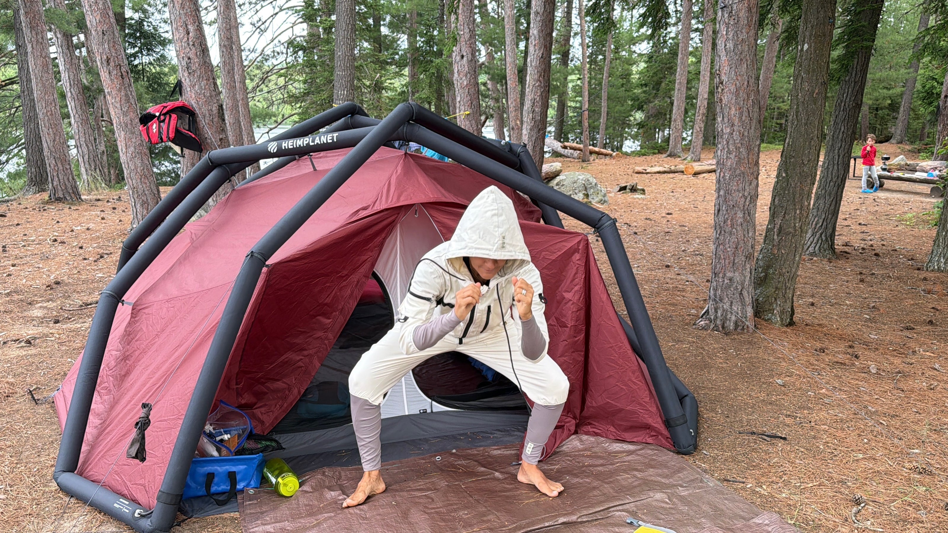 Camper wearing TickOffTicks protective suit at a campsite in the forest