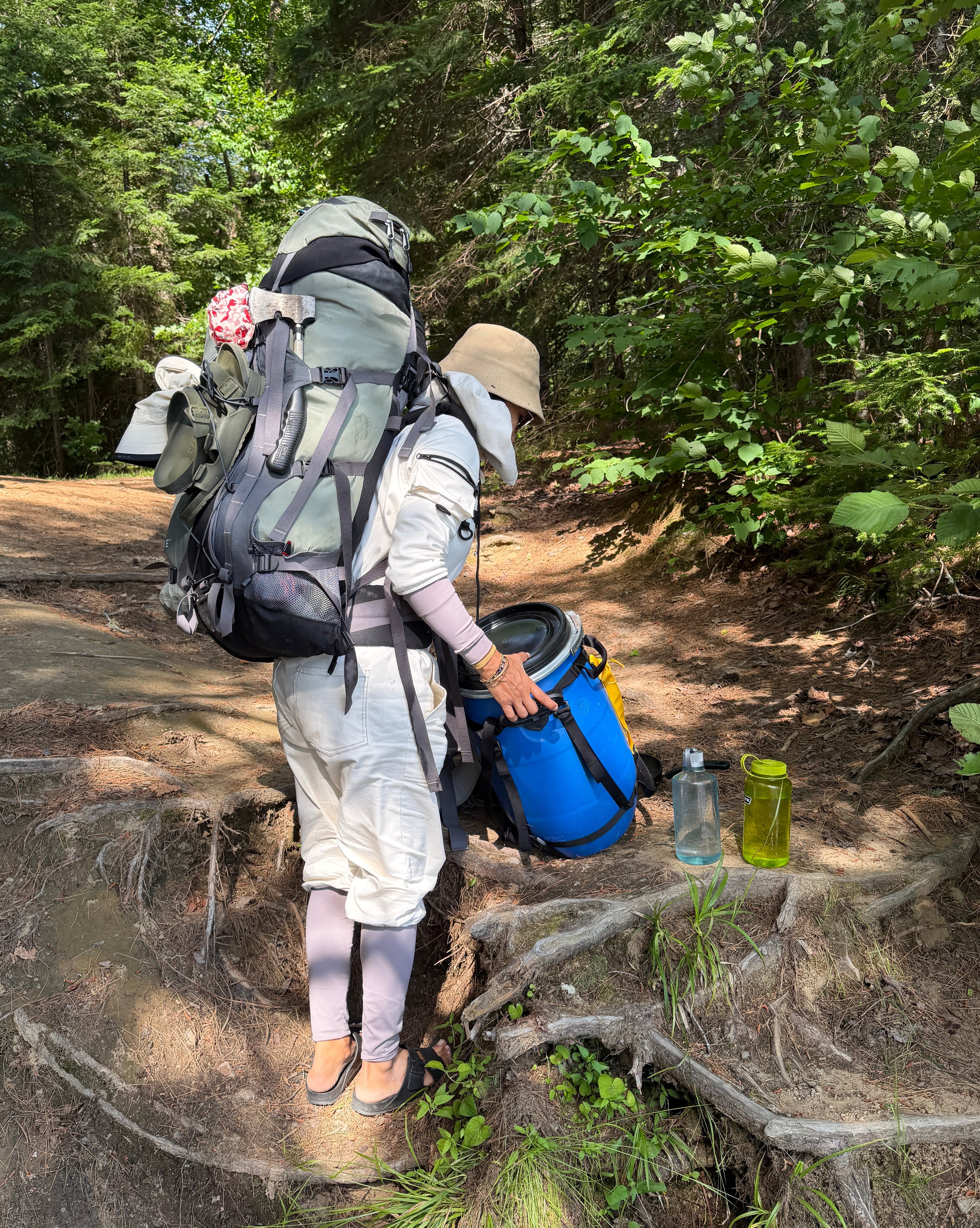 Camper getting ready to portage with TickOffTick suit to protect against mosquitos and ticks in the woods