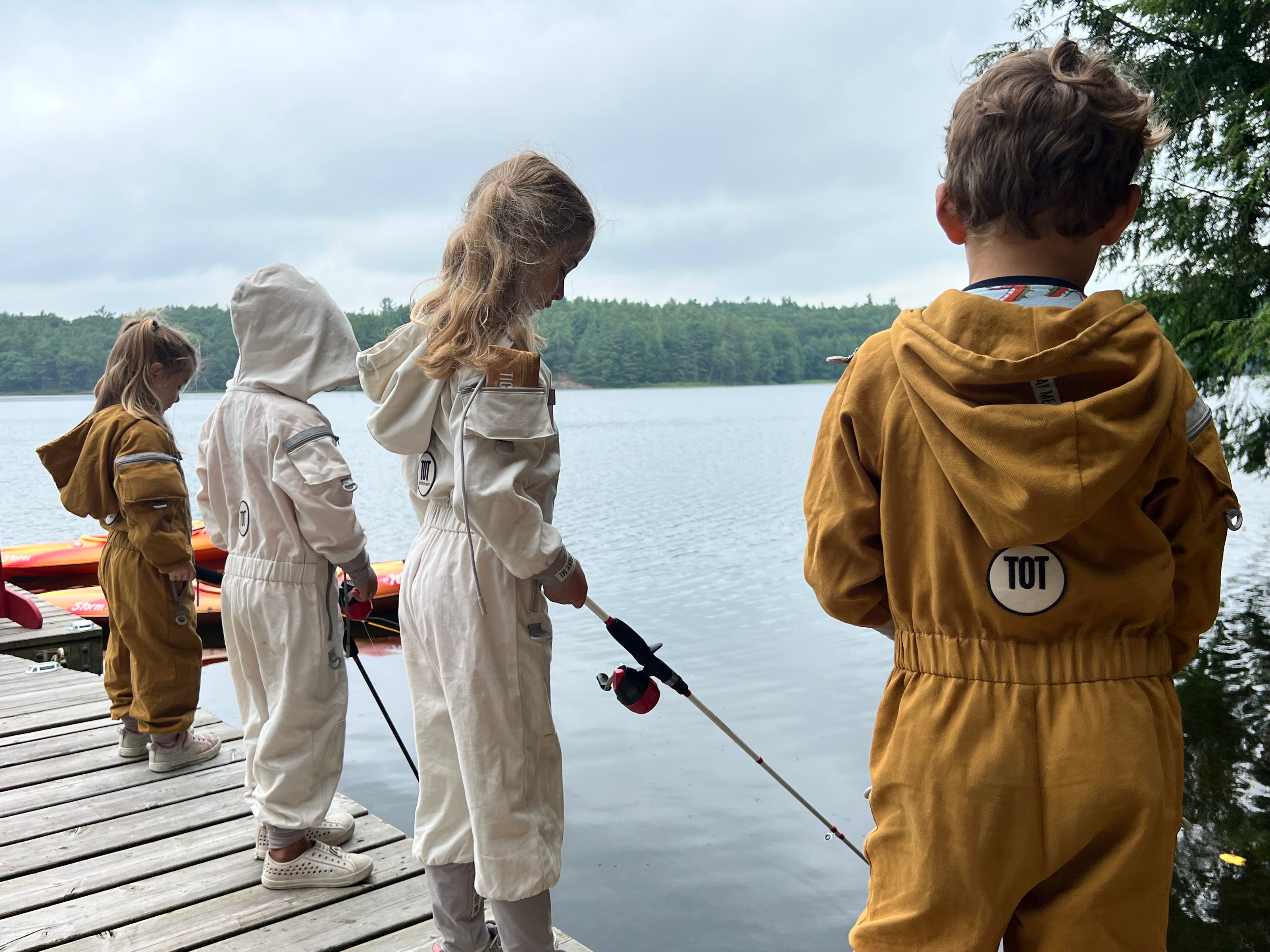 Family wearing TickOffTicks tick suits while fishing near a lake 